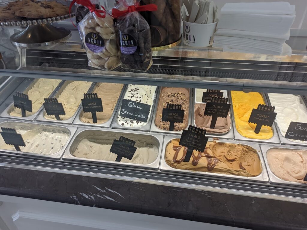 Delight in a selection at Néron Glacier, showcasing their finest gelato offerings such as Café Guatemala, Stracciatella, and Caramel Beurre Salé, each flavor meticulously labeled, ready to tempt the taste buds of ice cream enthusiasts in Nice.