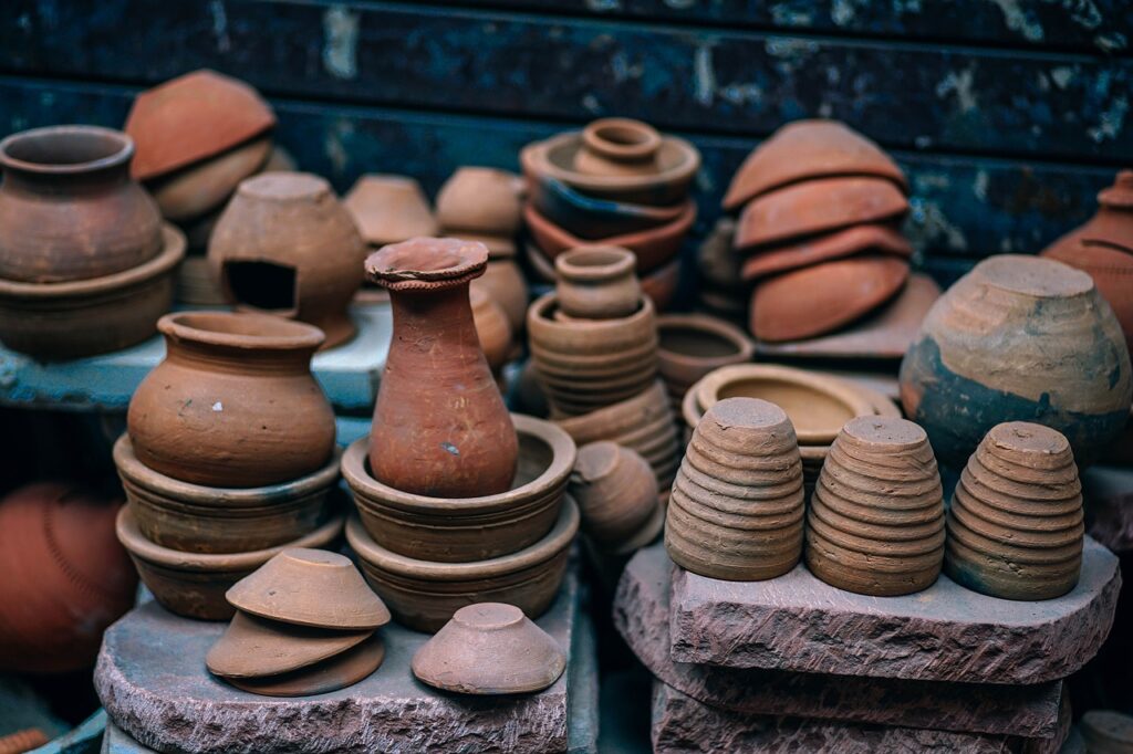 Assorted traditional terracotta pottery on display, featuring various shapes and sizes of earthenware, exemplifying the rustic craftsmanship ideal for Marseille souvenirs.