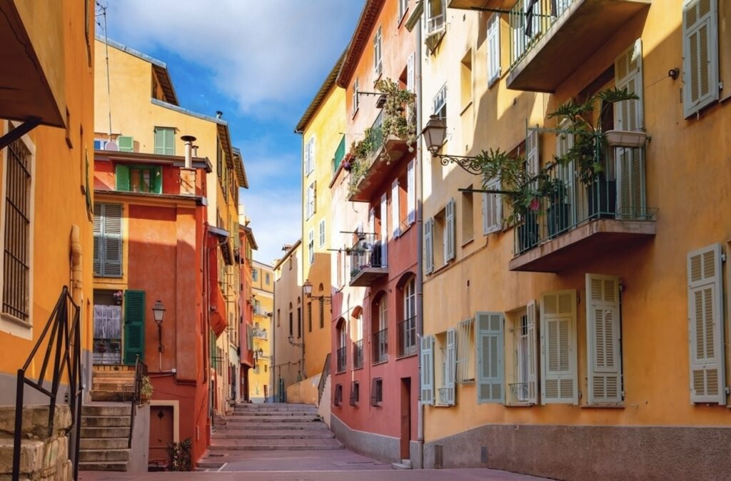 The charming, narrow streets of Old Nice, lined with colorful buildings and blooming balcony plants, epitomize the quaint and historical allure of the city, ideal for a 'Nice in one day' walking tour.