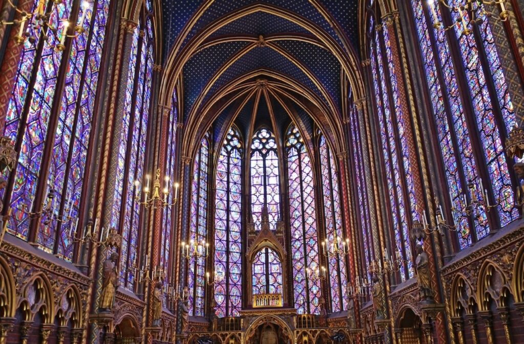 1st arrondissement in paris: The stunning stained glass windows of Sainte-Chapelle in the 1st arrondissement of Paris, featuring intricate Gothic architecture and vibrant colors that fill the chapel with light.