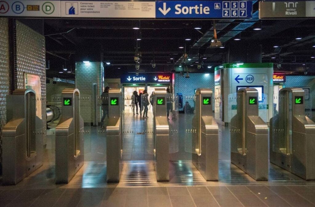 Turnstile exit gates inside Châtelet–Les Halles station, helping travelers understand how to use the Metro in Paris efficiently.